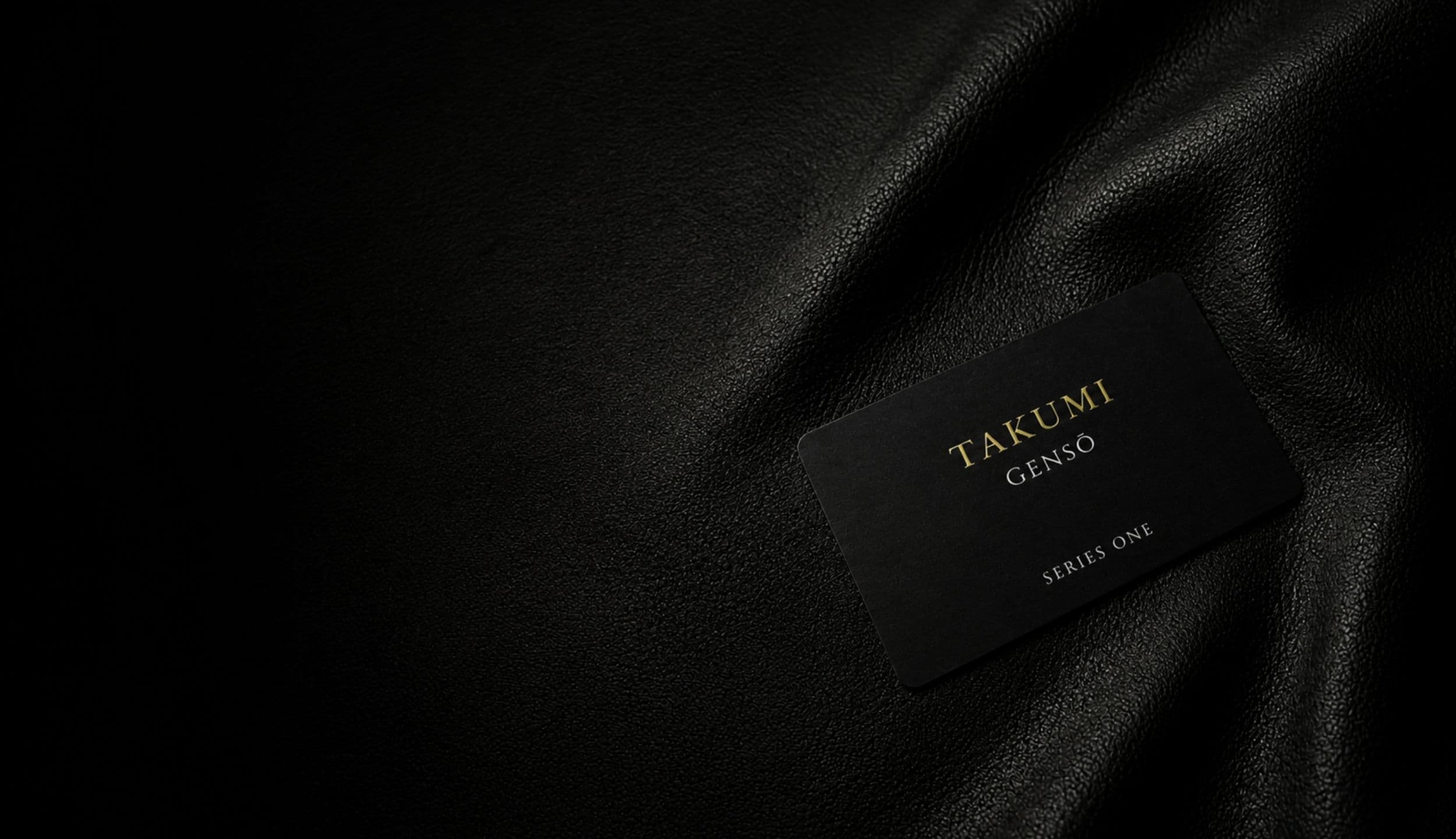 TAKUMI GENSŌ — Series One card edge in close macro on black leather, the words SERIES ONE in fine type