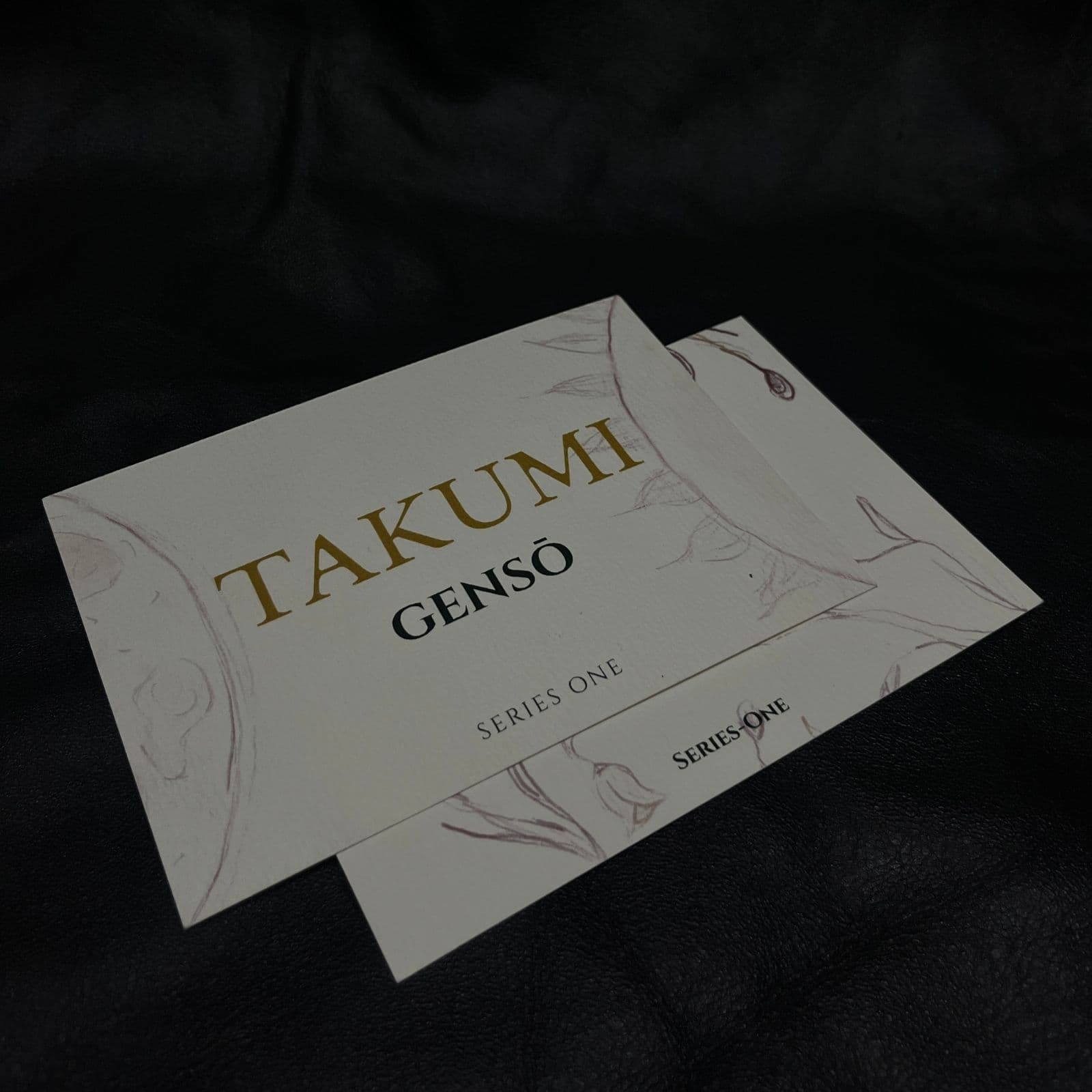 TAKUMI GENSŌ — Series One cards in cream textured stock, mauve line art and gold TAKUMI wordmark