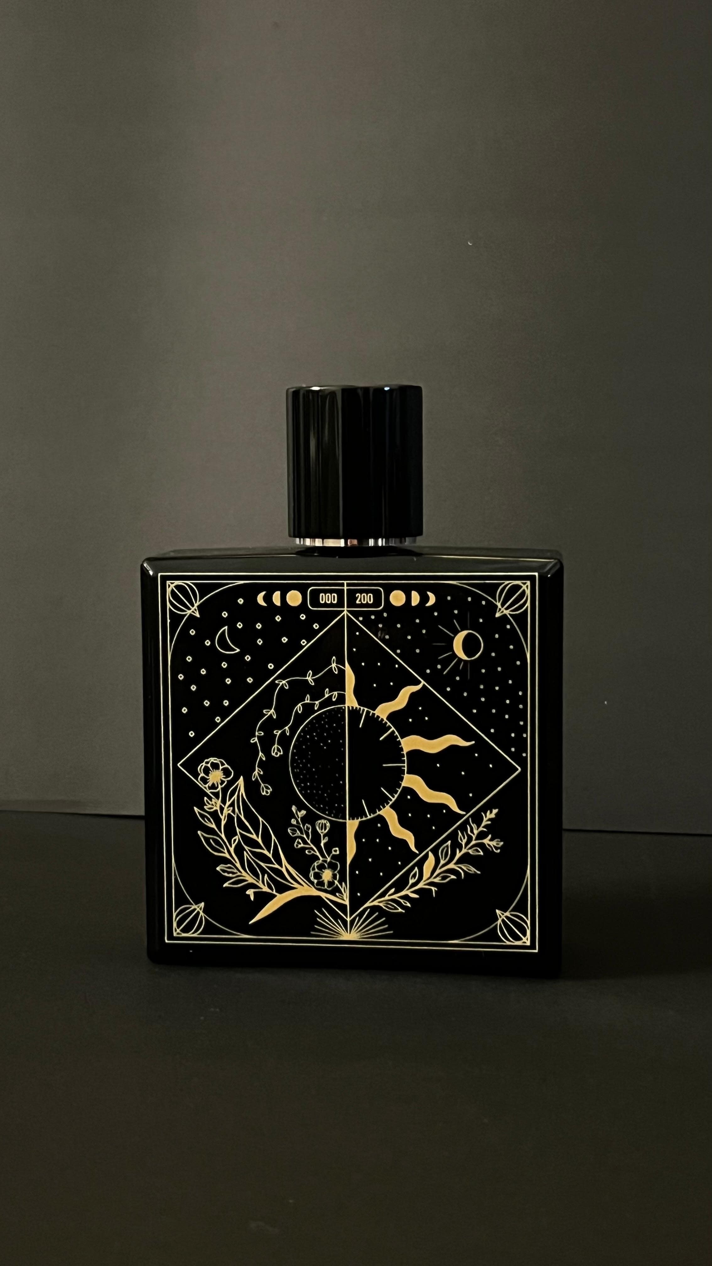 TAKUMI GENSŌ — gold celestial line work on the bottle: crescent moon and sun in one frame, constellation, botanicals, edition number engraved